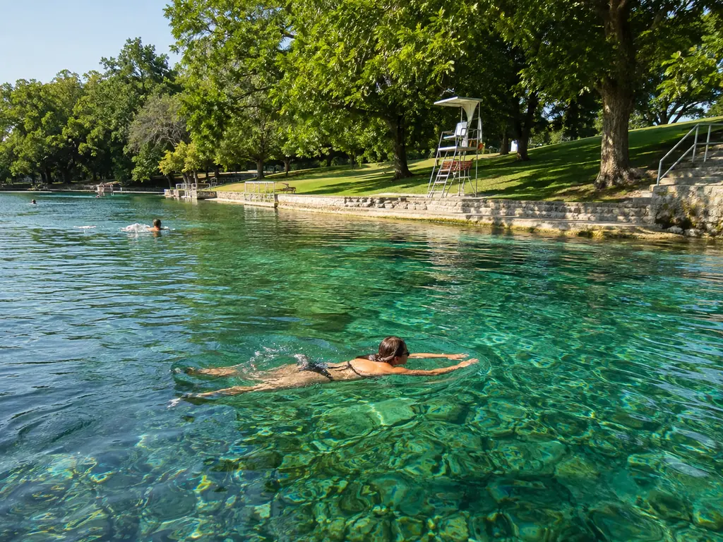 Swimmers in the clear spring water of Barton Springs Pool